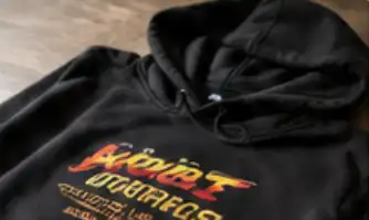A black hoodie with a colourful chest print